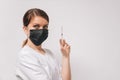 Closeup of a young beautiful woman doctor in on an isolated white background holds a syringe with a drug Royalty Free Stock Photo