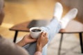 Closeup of young black woman warming her hands on cup of coffee, relaxing at home, empty space Royalty Free Stock Photo