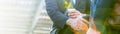 Closeup young business caucasian man shaking hands with cup of coffee in street city outdoors. Royalty Free Stock Photo