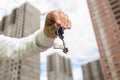 Closeup of young businessman hand holding keys from new home Royalty Free Stock Photo