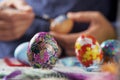 Young man decorating easter eggs