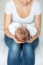 Closeup of young caring mother holding head of her little baby Royalty Free Stock Photo