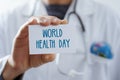 Doctor with signboard with text world health day