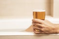 Young man drinking a beer on the bathtub Royalty Free Stock Photo