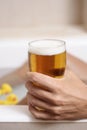 Man relaxing in the bathtub with a beer Royalty Free Stock Photo