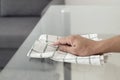 Young man cleaning a glass table Royalty Free Stock Photo