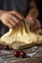 Preparing a coca de cireres, a cherry flat cake