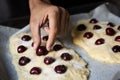 Preparing a coca de cireres, a cherry flat cake