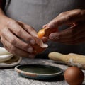 Young man separating the yolk of an egg Royalty Free Stock Photo