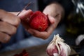 young man peeling a scalded tomato