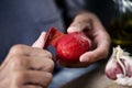Man peeling a scalded tomato Royalty Free Stock Photo