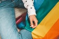 Closeup of young caucasian millennial hippie woman with painted rainbow flag in heart shape painted in wrist. Rainbow