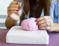 Closeup young caucasian woman hands making wool dry felting tutorial