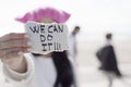 Woman with a pink hat and the text we can do it