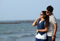 Closeup of a young couple enjoying the beauty of the sea. Romantic pose of Asian couple in honeymoon time Royalty Free Stock Photo