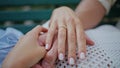 Closeup young couple hands holding at romantic date. Engaged man woman love Royalty Free Stock Photo