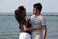 Young couple hugging and holding each other. Asian couple enjoying the valentine vacation at the sea beach in honeymoon Royalty Free Stock Photo