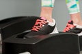 Closeup of young female feet working on stepper Royalty Free Stock Photo