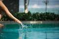 Closeup young female leg make splash of blue water in swimming pool Royalty Free Stock Photo