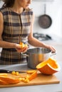 Closeup on young housewife cooking pumpkin Royalty Free Stock Photo