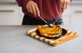 Closeup on young housewife eating baked pumpkin