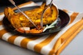 Closeup on young housewife eating baked pumpkin