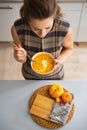 Closeup on young housewife eating pumpkin soup Royalty Free Stock Photo