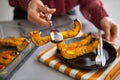 Closeup on young housewife serving baked pumpkin