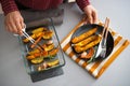 Closeup on young housewife serving baked pumpkin Royalty Free Stock Photo