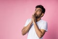 Portrait of handsome Indian guy standing on pink background Royalty Free Stock Photo