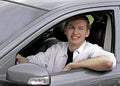 Closeup of a Young male smiling while sitting in his With Arm on Window