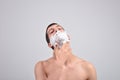 Closeup of young man preparing to shave, he puts foam on his c Royalty Free Stock Photo