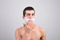 Closeup of a young man preparing to shave, he puts foam on his c Royalty Free Stock Photo