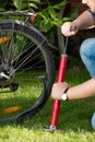 Closeup of young man pumping bicycle tyre Royalty Free Stock Photo