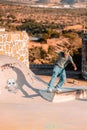Closeup of a young man on a skateboard performing a trick on a ramp in Morocco