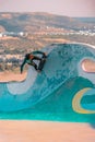 Closeup of a young man on a skateboard performing a trick on a ramp in Morocco