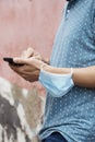 Man using his smartphone wearing a mask in his arm Royalty Free Stock Photo