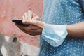 Man using his smartphone wearing a mask in his arm Royalty Free Stock Photo