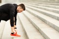 Closeup of Young Man Tying Sports Shoe In City Royalty Free Stock Photo