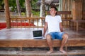 Closeup young man using tablet computer on exotic Royalty Free Stock Photo