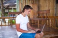 Closeup young man using tablet computer on exotic Royalty Free Stock Photo