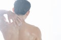 Closeup young man washing hair with with shampoo isolated on white background, vintage tone, selective focus Royalty Free Stock Photo