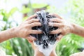 Closeup young man washing hair with shampoo outdoor, health care concept, selective focus Royalty Free Stock Photo