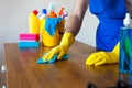 Closeup Of Young Man Wearing Apron Cleaning Kitchen Worktop Royalty Free Stock Photo