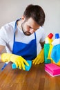 Closeup Of Young Man Wearing Apron Cleaning Kitchen Worktop Royalty Free Stock Photo