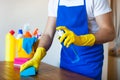 Closeup Of Young Man Wearing Apron Cleaning Kitchen Worktop Royalty Free Stock Photo