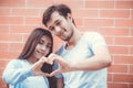 Closeup of young man and woman asian making heart shape with hand.