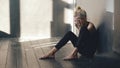 Closeup of young teenage girl dancer crying after loss perfomance sits on floor in hall indoors Royalty Free Stock Photo