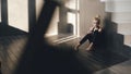 Closeup of young teenage girl dancer crying after loss perfomance sits on floor in hall indoors Royalty Free Stock Photo