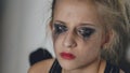 Closeup of young teenage girl dancer crying after loss perfomance sits on floor in hall indoors Royalty Free Stock Photo